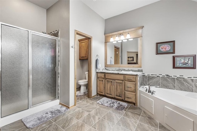 full bathroom featuring shower with separate bathtub, vanity, and toilet