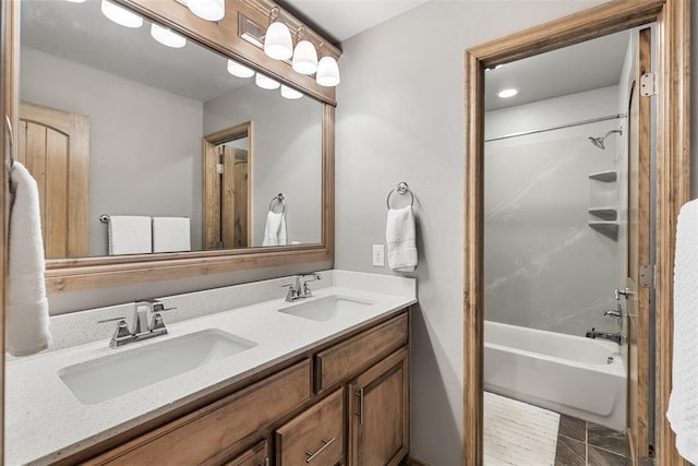 bathroom with shower / bathing tub combination and vanity