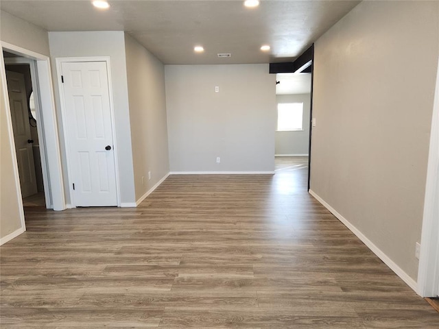 spare room featuring wood-type flooring