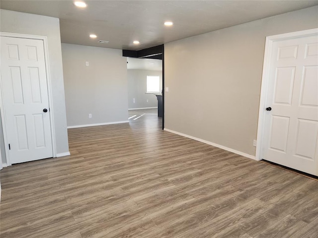 spare room with hardwood / wood-style flooring