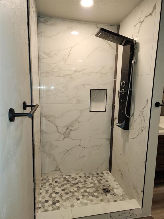 bathroom with tiled shower