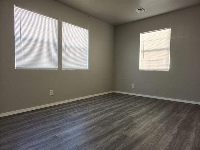 spare room with dark hardwood / wood-style flooring