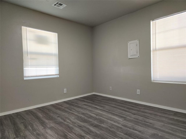 spare room with dark hardwood / wood-style flooring