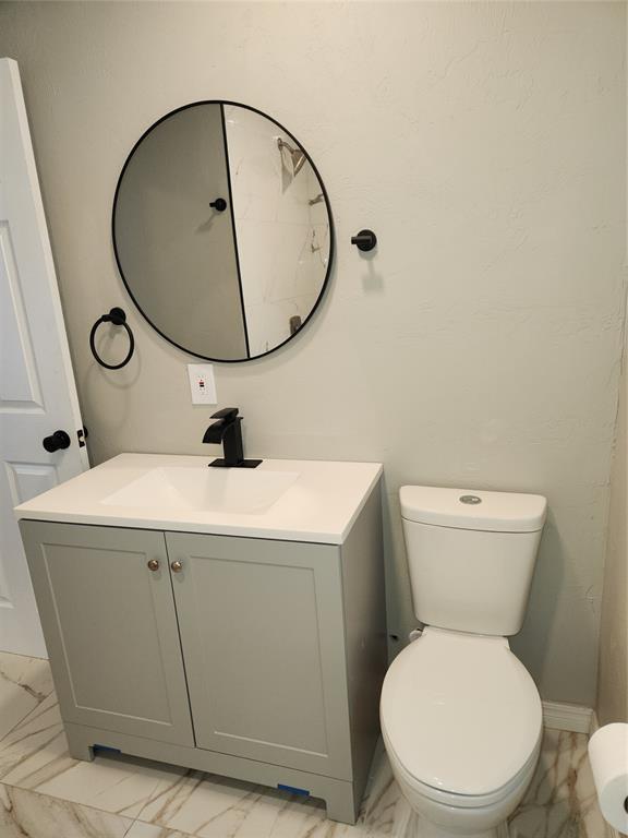 bathroom featuring toilet and vanity