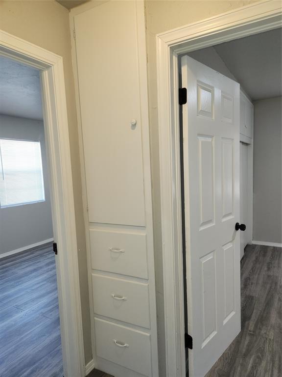 corridor with dark hardwood / wood-style floors