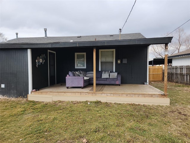 rear view of house featuring a yard, outdoor lounge area, and a wooden deck