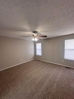 carpeted empty room featuring ceiling fan