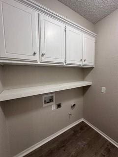 clothes washing area with electric dryer hookup, cabinets, dark wood-type flooring, hookup for a washing machine, and a textured ceiling