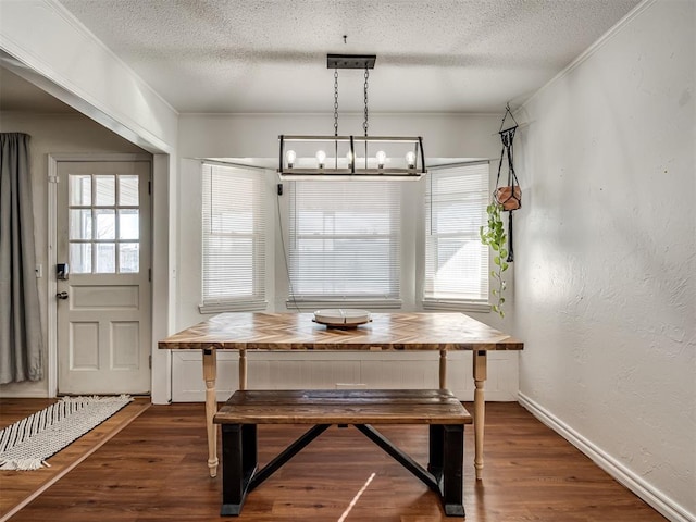 dining area with crown molding, plenty of natural light, dark hardwood / wood-style floors, and breakfast area