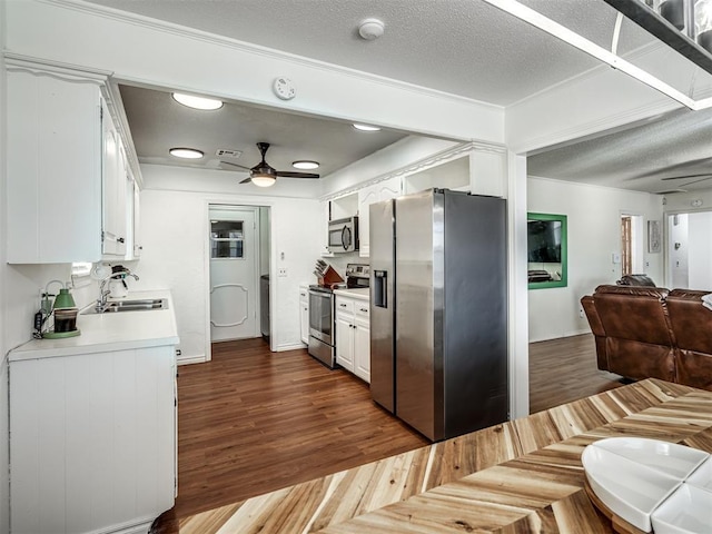 kitchen featuring sink, stainless steel appliances, white cabinets, and ceiling fan