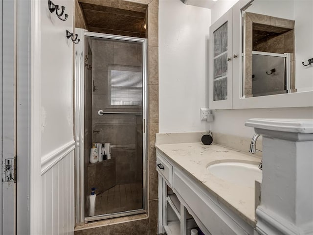 bathroom featuring walk in shower and vanity