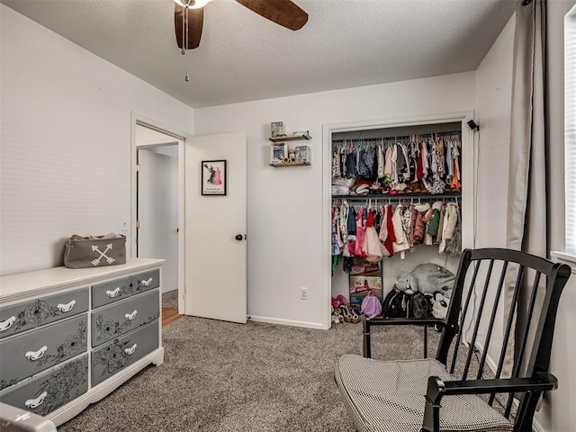 bedroom featuring ceiling fan, a closet, a textured ceiling, and carpet flooring