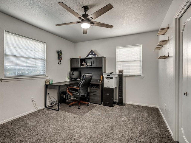 carpeted home office featuring ceiling fan and a textured ceiling