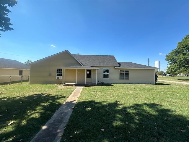 back of house featuring a lawn