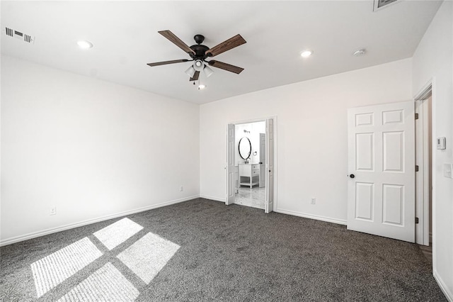 unfurnished bedroom with visible vents, dark carpet, and recessed lighting