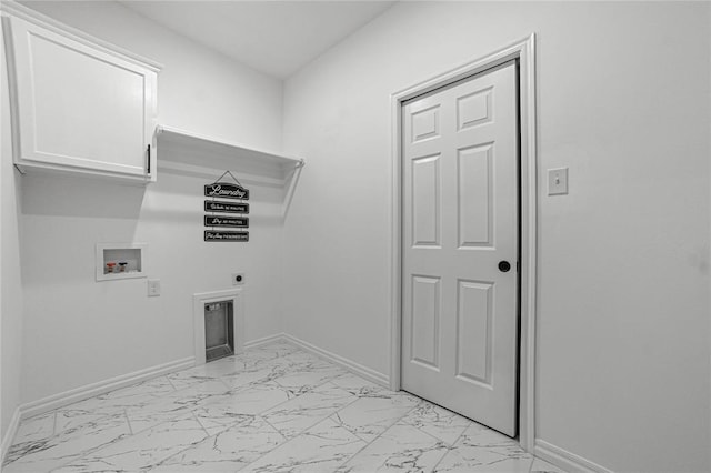 washroom featuring marble finish floor, washer hookup, cabinet space, and baseboards