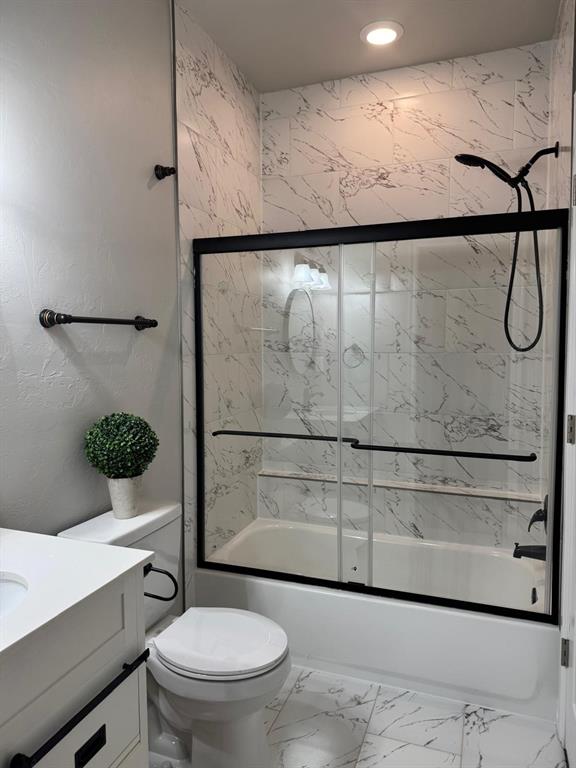 bathroom with bath / shower combo with glass door, toilet, marble finish floor, vanity, and recessed lighting