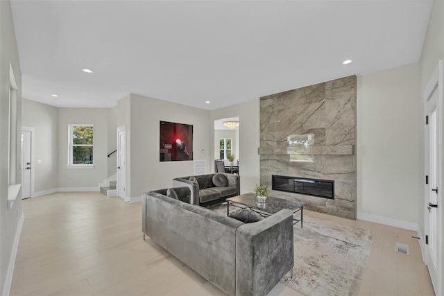 living room featuring a fireplace and light hardwood / wood-style floors