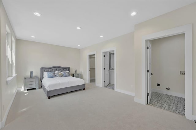 carpeted bedroom with connected bathroom, a spacious closet, and a closet