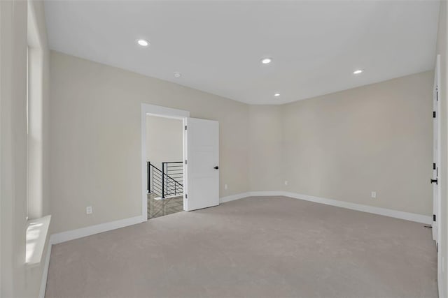 empty room featuring light colored carpet