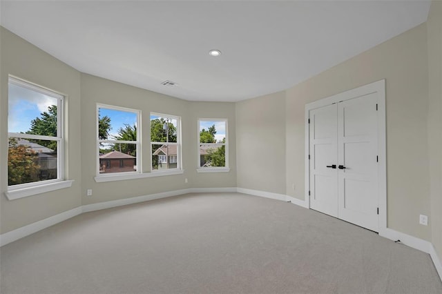 spare room featuring light carpet