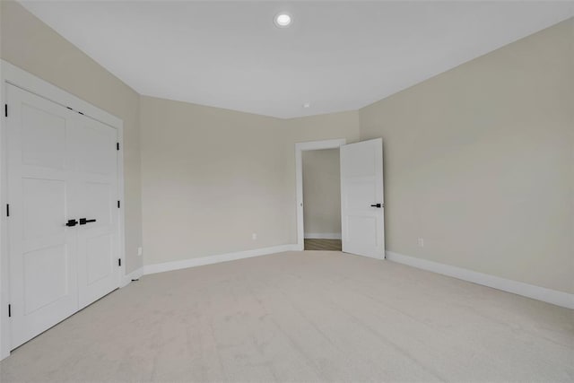 unfurnished bedroom with light carpet