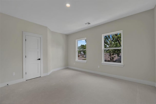 spare room with light carpet