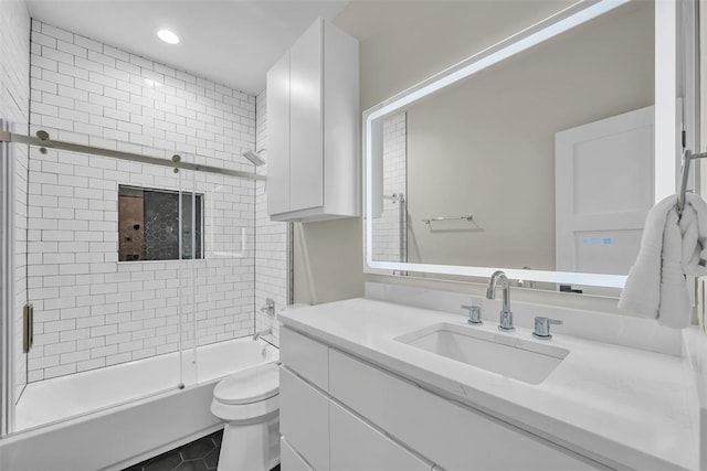 full bathroom featuring tile patterned flooring, vanity, toilet, and shower / bath combination with glass door