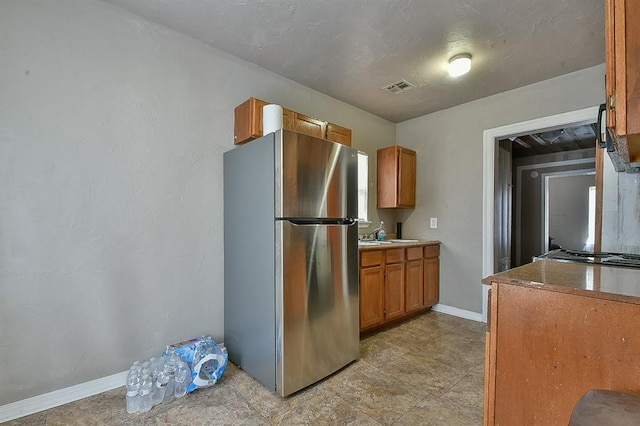 kitchen featuring stainless steel refrigerator and sink