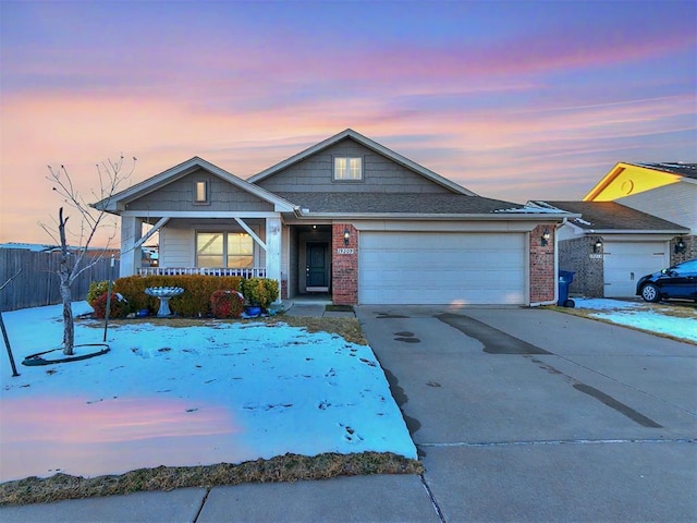 view of front of home featuring covered porch and a garage