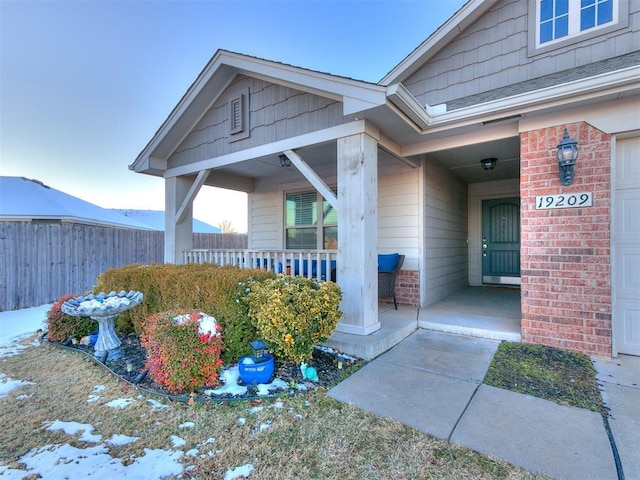 entrance to property featuring covered porch