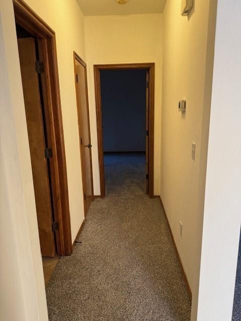 hall featuring dark carpet