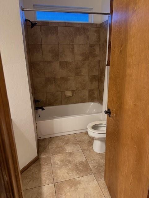 bathroom featuring tiled shower / bath combo and toilet