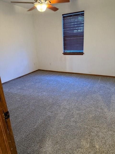 spare room with carpet and ceiling fan