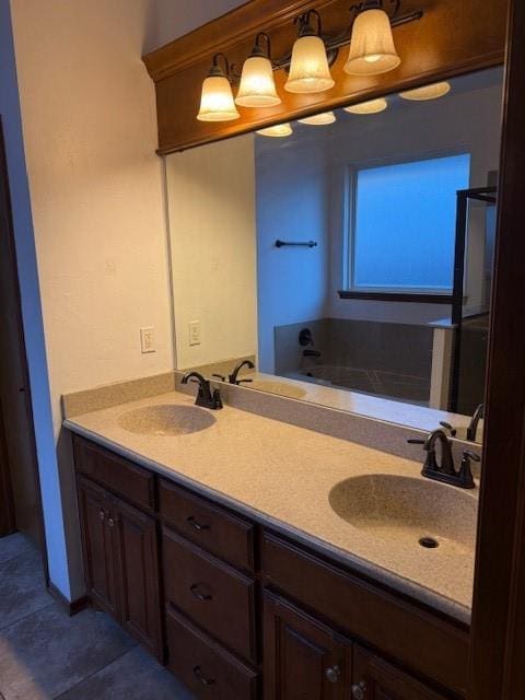 bathroom with tile patterned floors, vanity, and a washtub