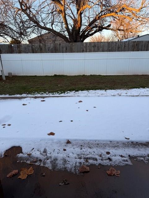 view of yard layered in snow