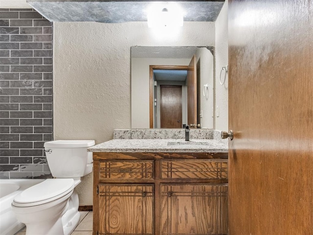 bathroom with toilet, tile patterned flooring, and vanity