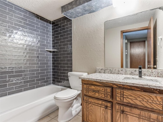 full bathroom featuring tile patterned floors, tiled shower / bath, toilet, a textured ceiling, and vanity