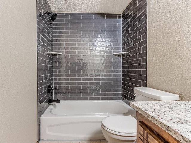 full bathroom featuring a textured ceiling, toilet, vanity, and tiled shower / bath