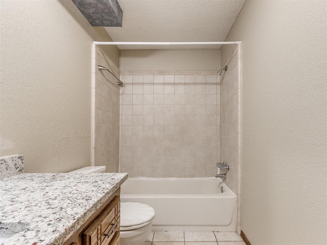 full bathroom with a textured ceiling, tiled shower / bath combo, tile patterned floors, vanity, and toilet