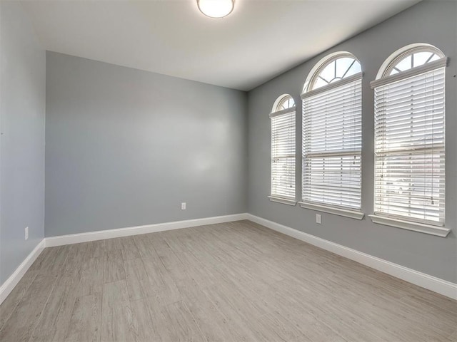 unfurnished room with light wood-type flooring