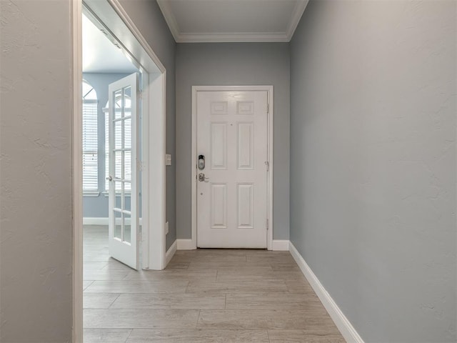 doorway featuring crown molding and light hardwood / wood-style flooring