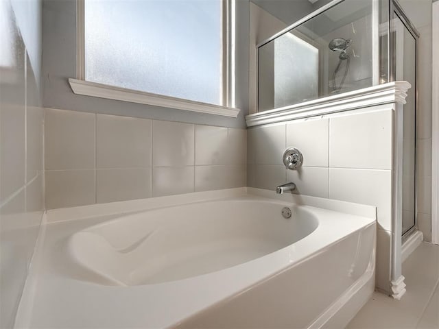 bathroom featuring shower with separate bathtub