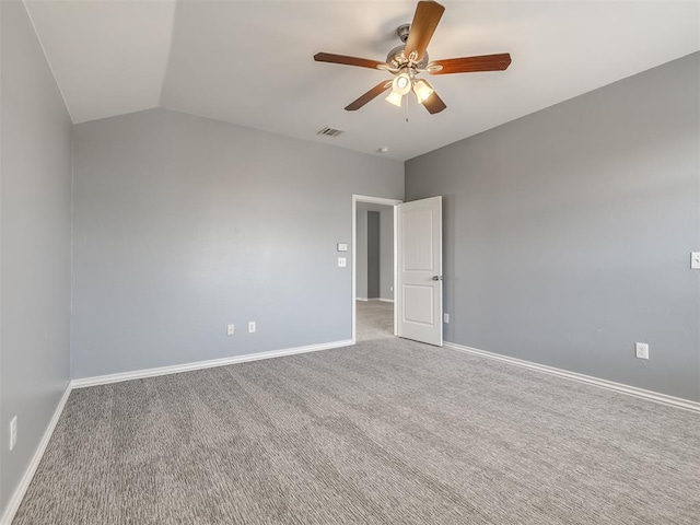 carpeted empty room with vaulted ceiling and ceiling fan