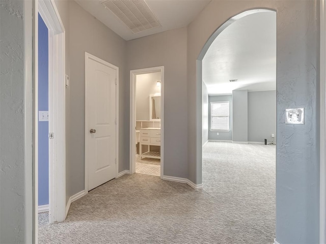 hallway with light colored carpet