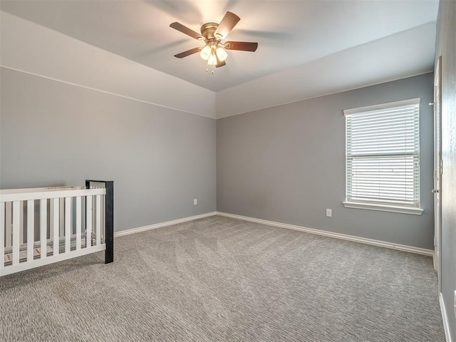 unfurnished bedroom with ceiling fan, light carpet, and lofted ceiling