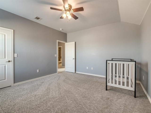 unfurnished bedroom with ceiling fan, light colored carpet, and vaulted ceiling