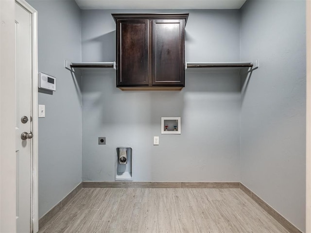 laundry room featuring washer hookup, electric dryer hookup, cabinets, and light wood-type flooring