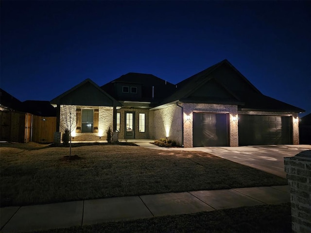 view of front facade with fence, concrete driveway, central AC unit, a garage, and a yard