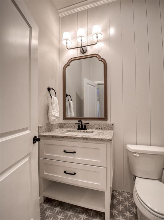 bathroom with vanity, tile patterned floors, and toilet